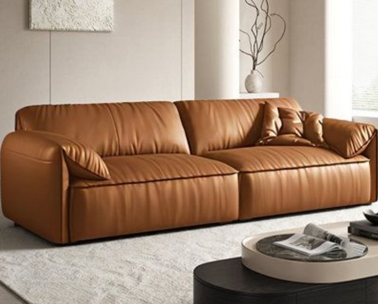 A brown leather couch in a room